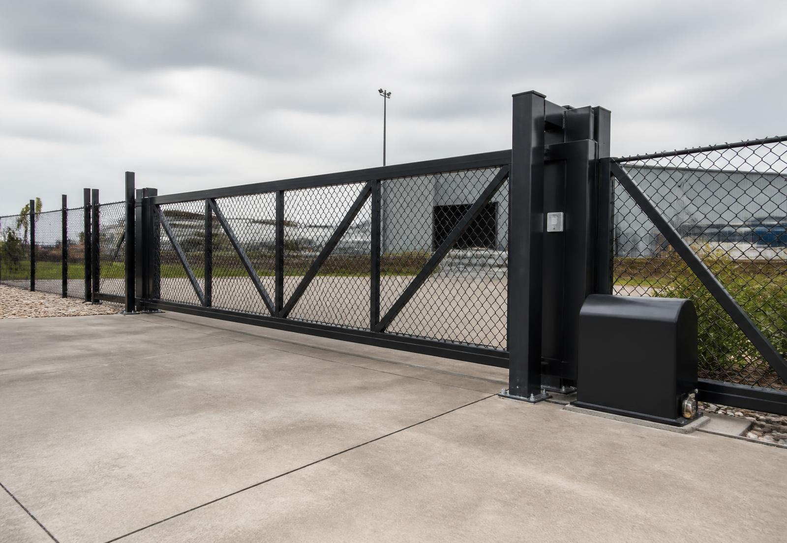 Custom fabricated steel cantilever gate with gate operator at an industrial entrance